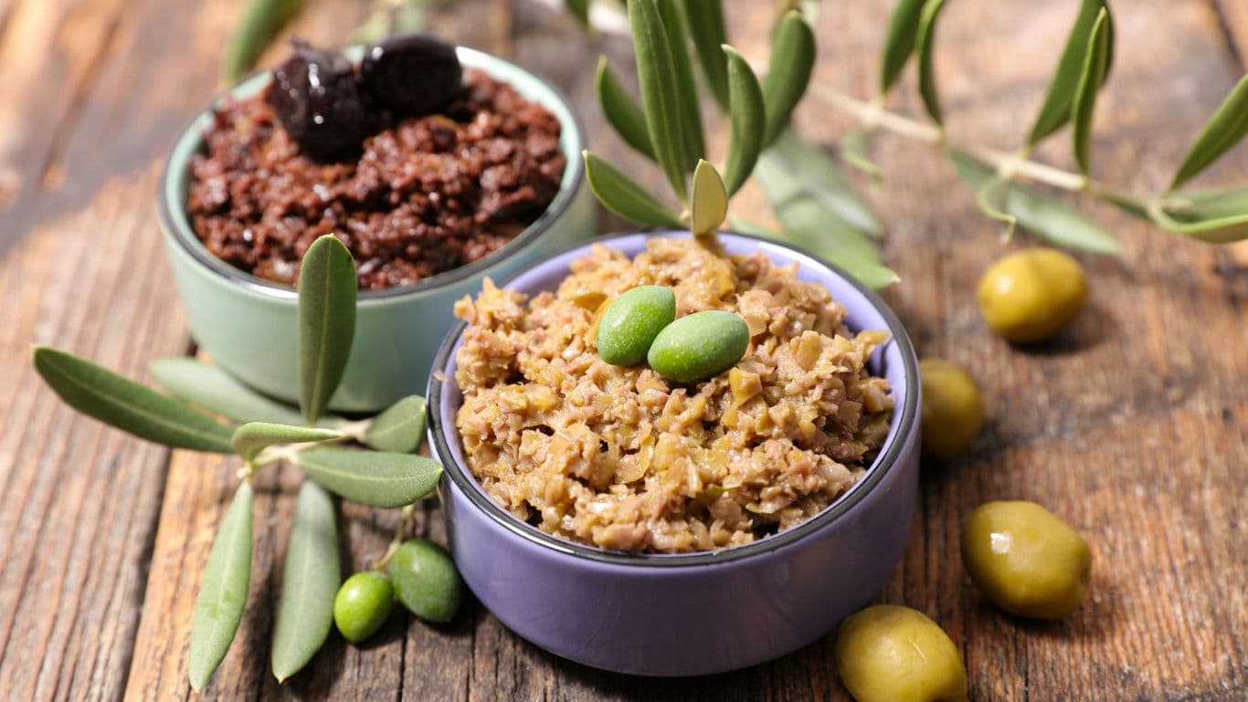 Bowls of green and black olive tapenade