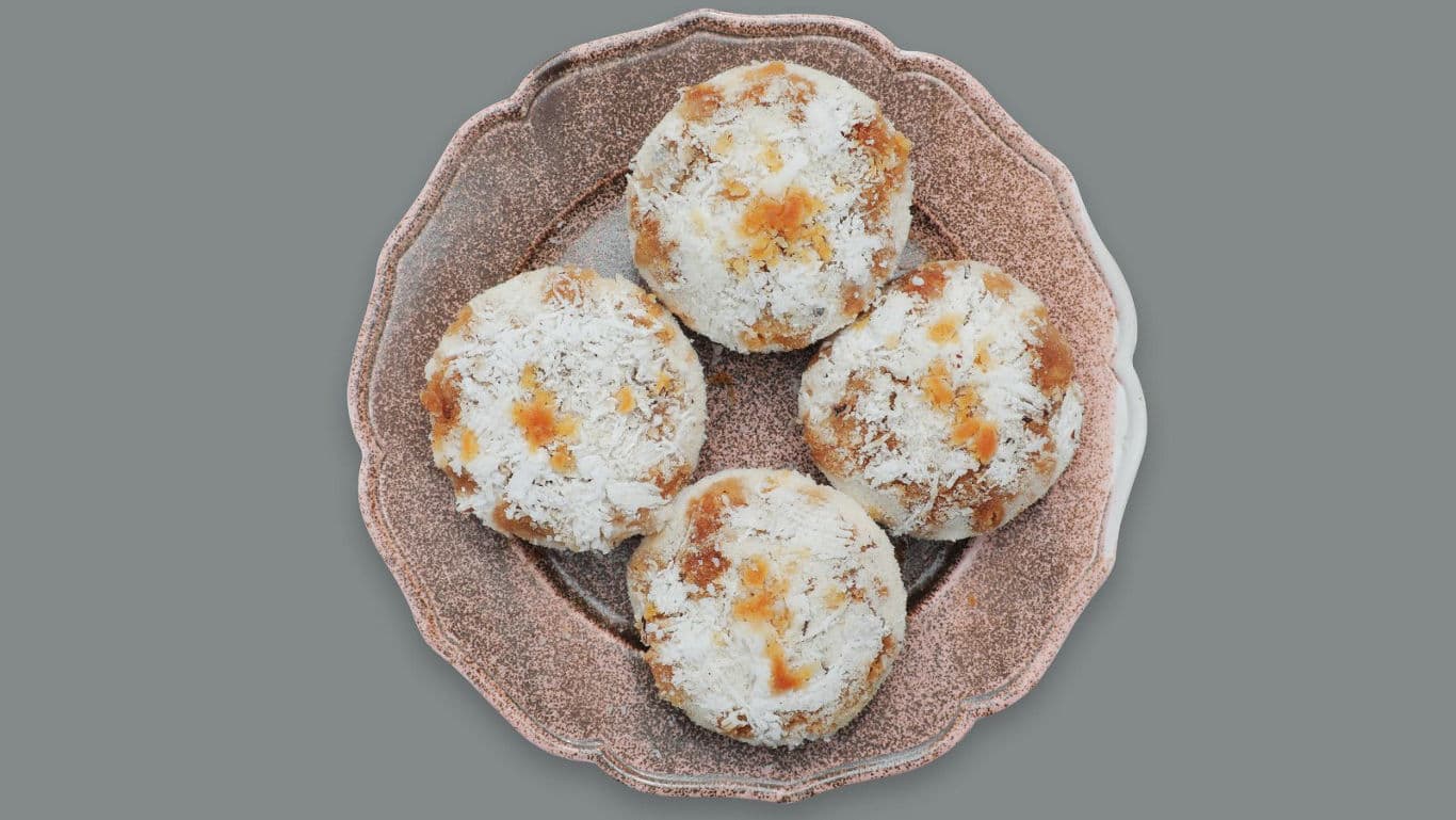 Four Powdered Sugar Cookies on Decorative Plate