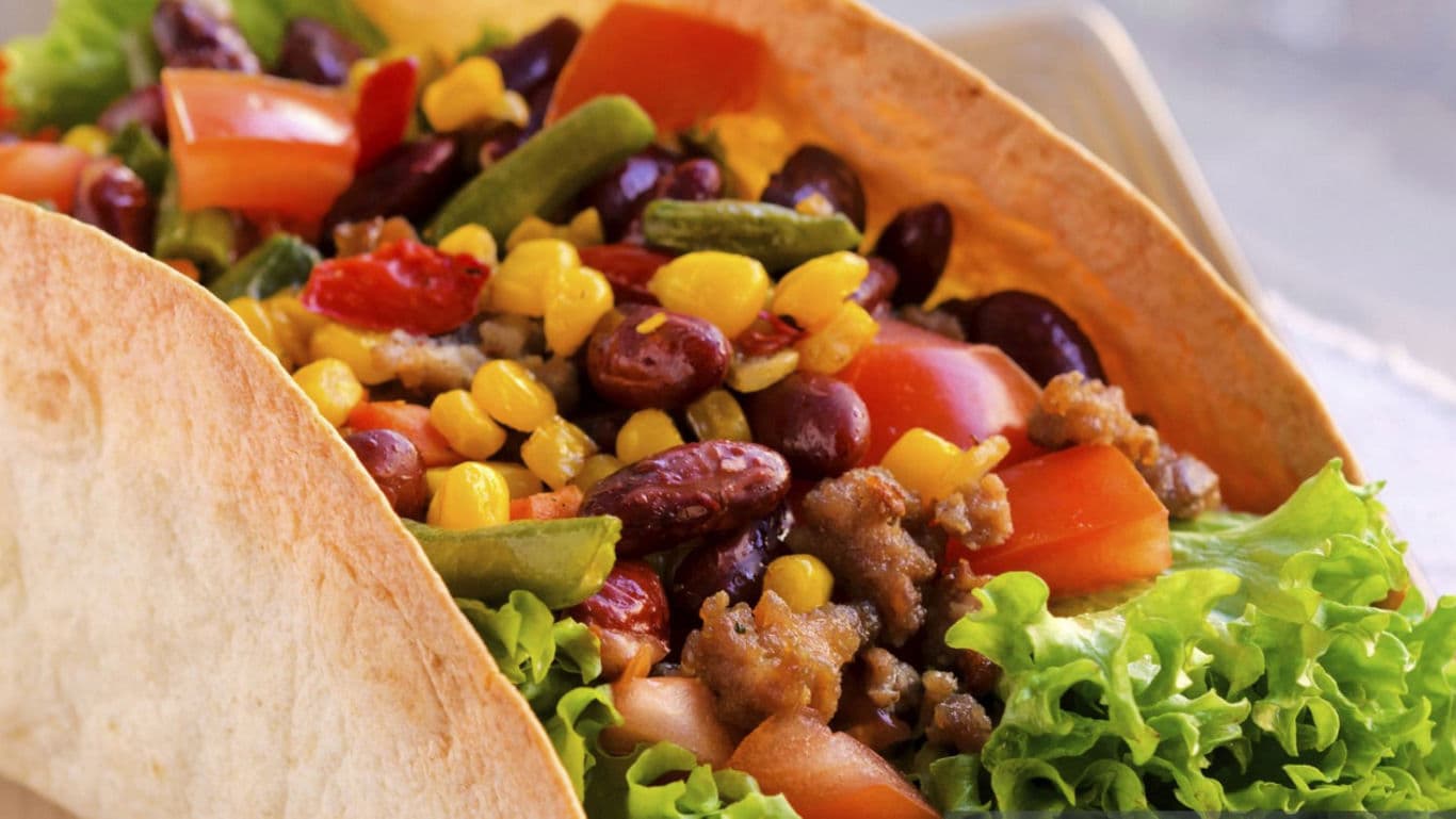 Colorful taco filled with beans and vegetables