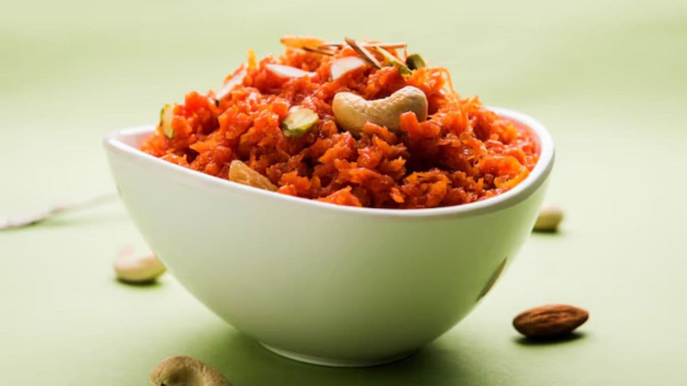 Bowl of vibrant carrot dessert with nuts