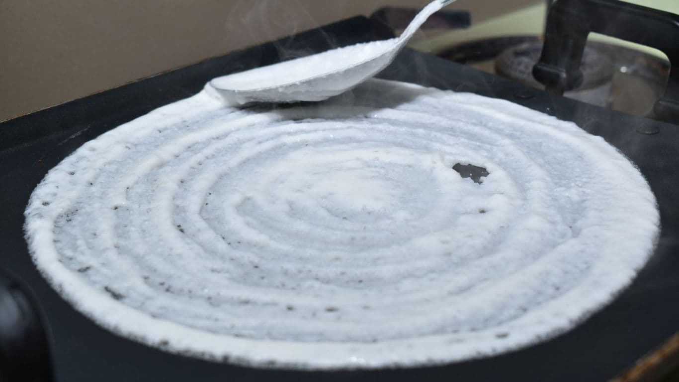 Cooking dosa on a hot griddle