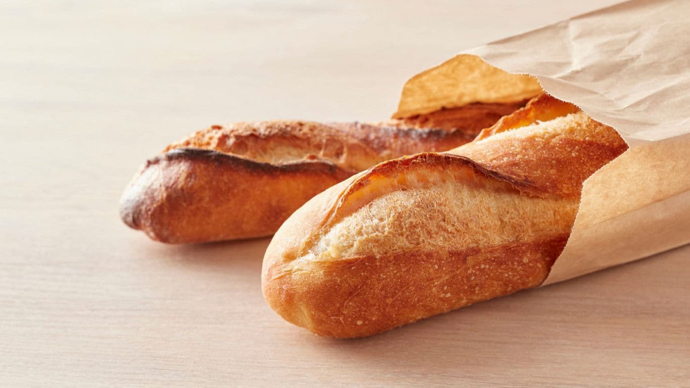 Fresh crusty baguettes in paper bag