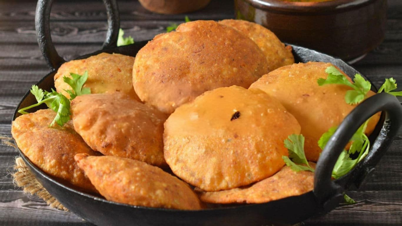 Crispy fried puris in black skillet