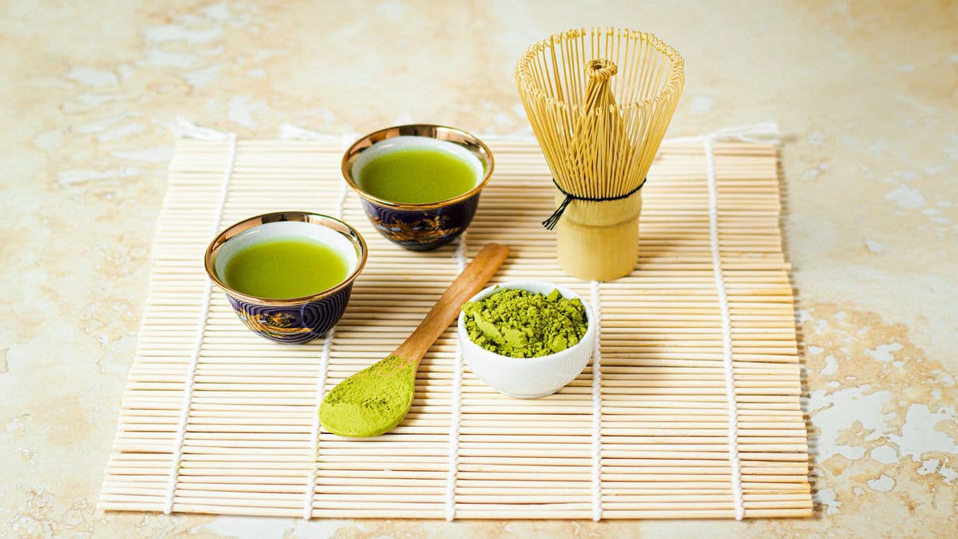 A top-view image of matcha and its preparation tools.