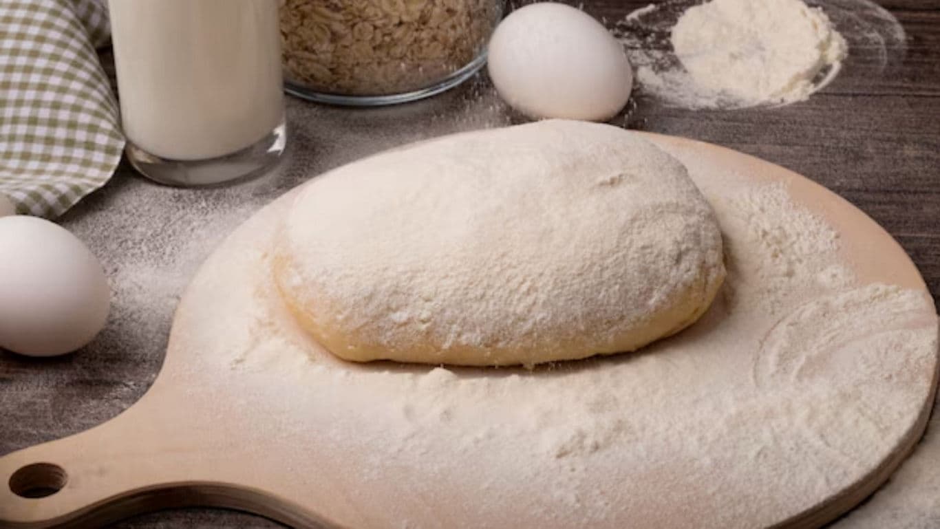 Floured Dough Ball with Eggs and Milk on Table