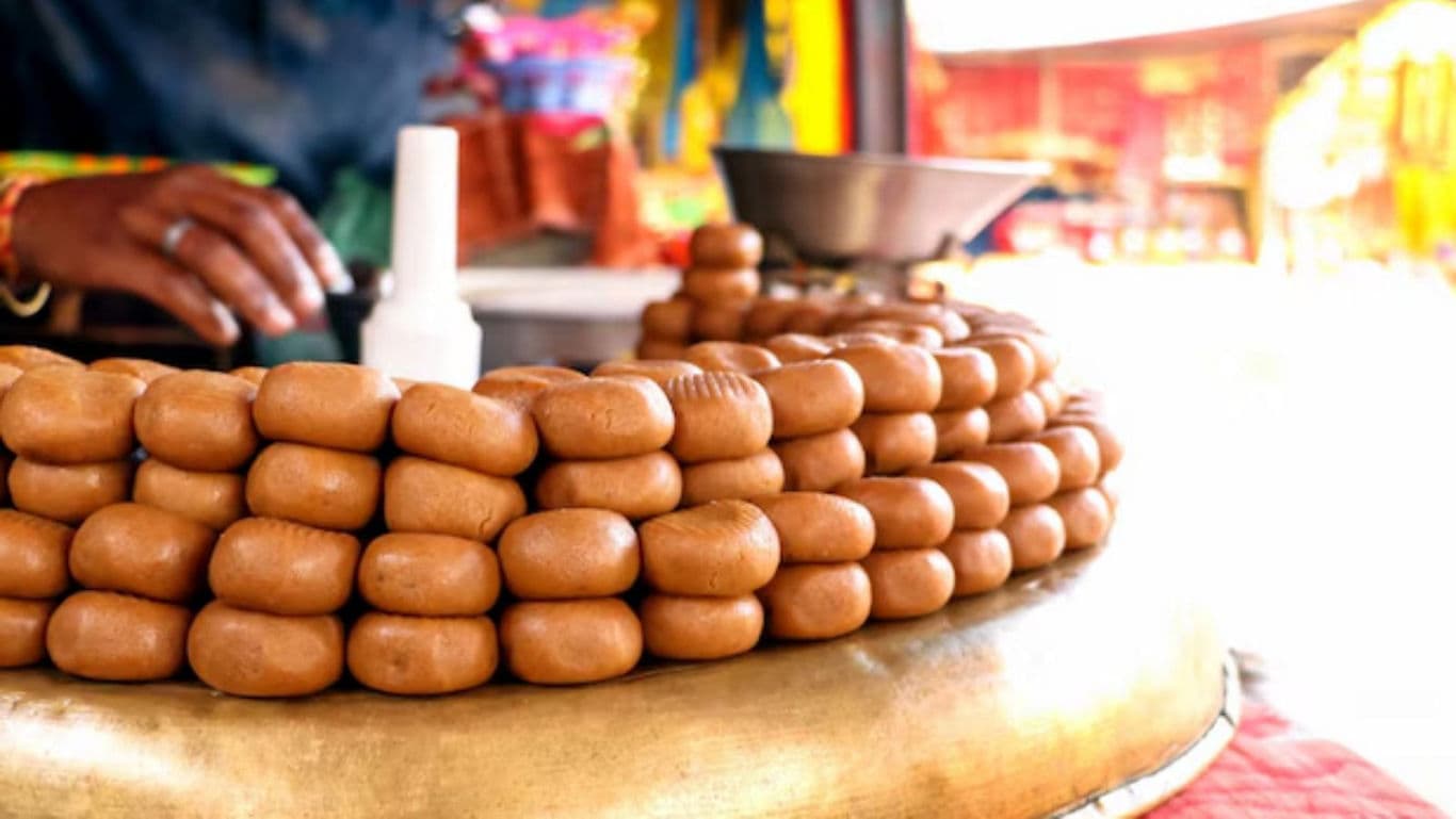 Traditional Indian Sweets Displayed at Outdoor Market Stall