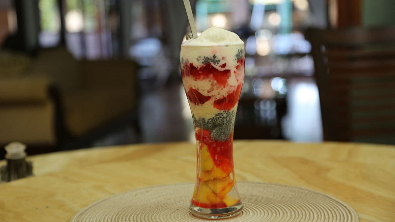 Colorful layered ice cream dessert in glass