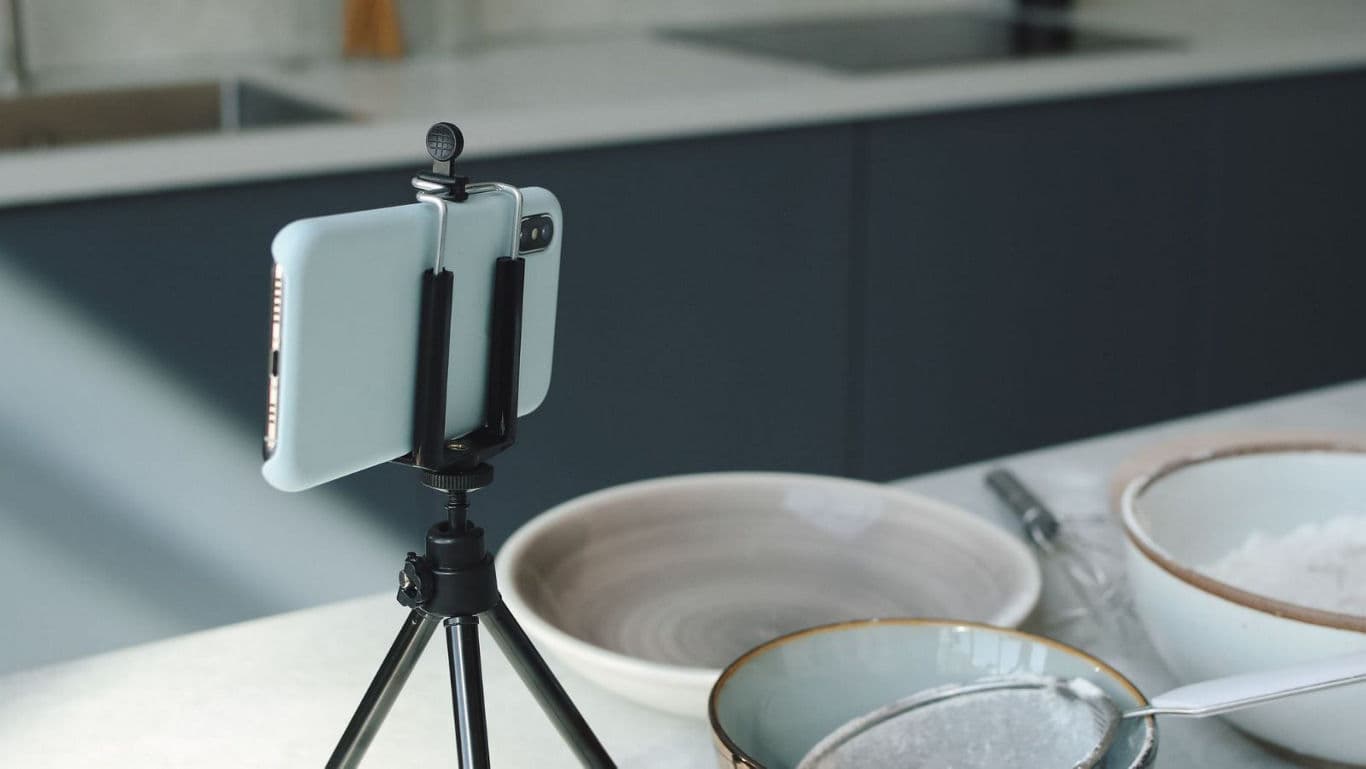 Smartphone on tripod filming kitchen scene