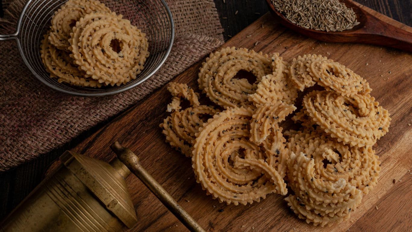 Traditional spiral fried snack on wooden board