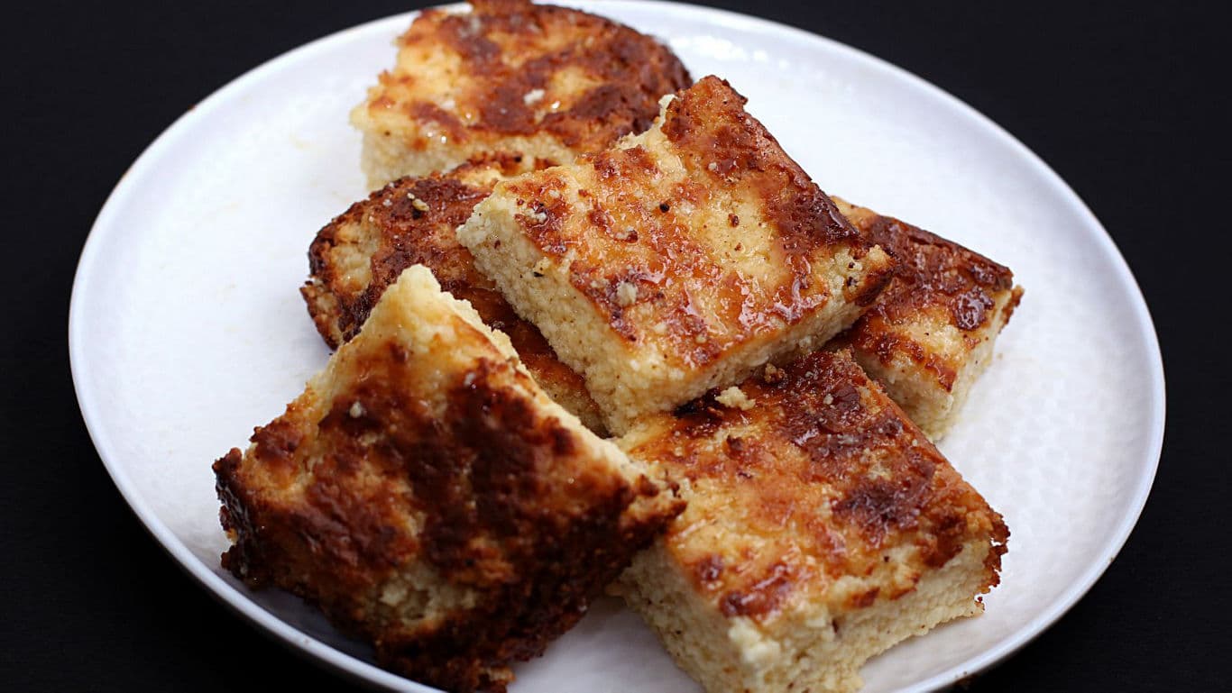 Golden baked dessert squares on plate
