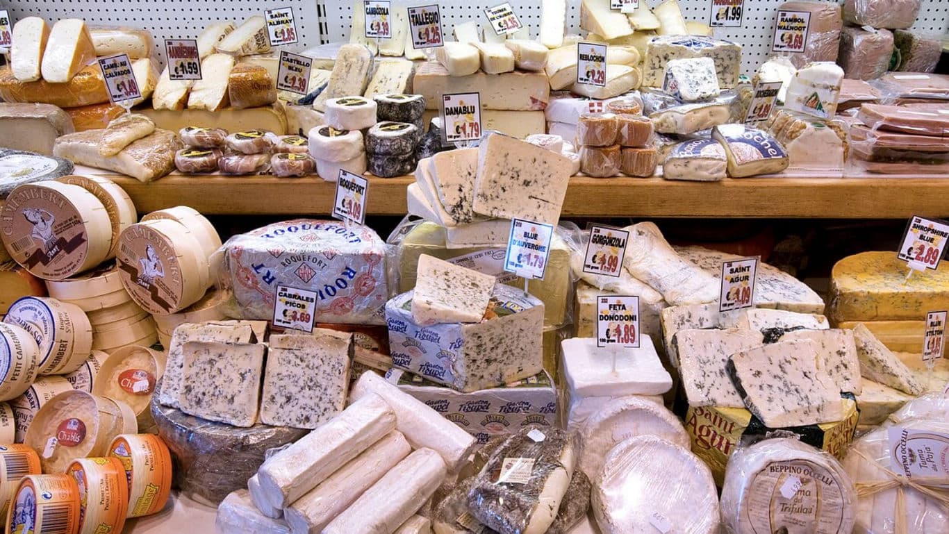 Assorted Cheeses Displayed at Market Counter