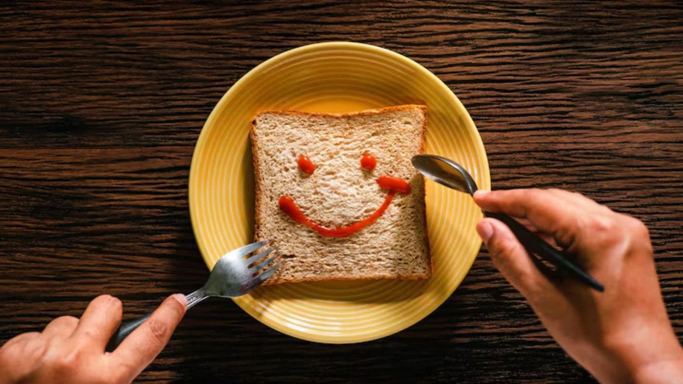 Smiley face on bread with utensils