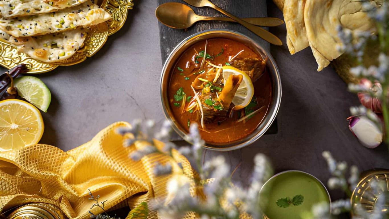 Indian curry with naan bread and lemon garnish