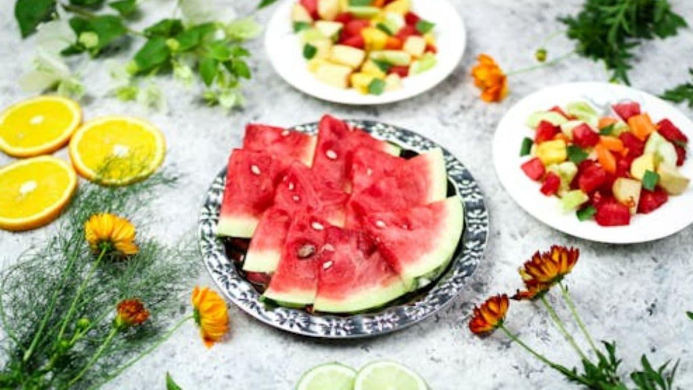 Fresh Watermelon Slices and Colorful Fruit Salad Plates