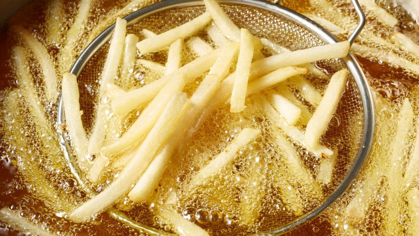 Golden French Fries in Hot Oil