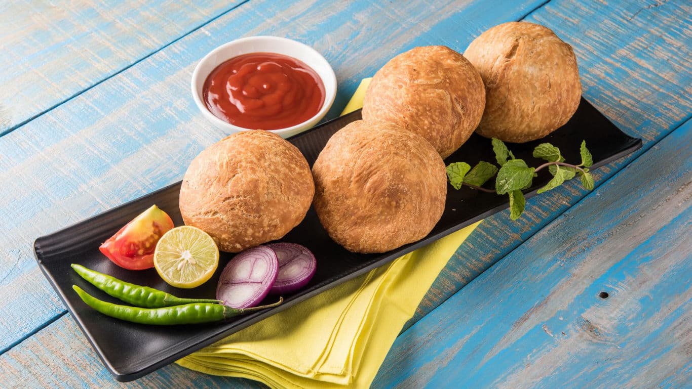 Indian fried snacks with chutney and garnish