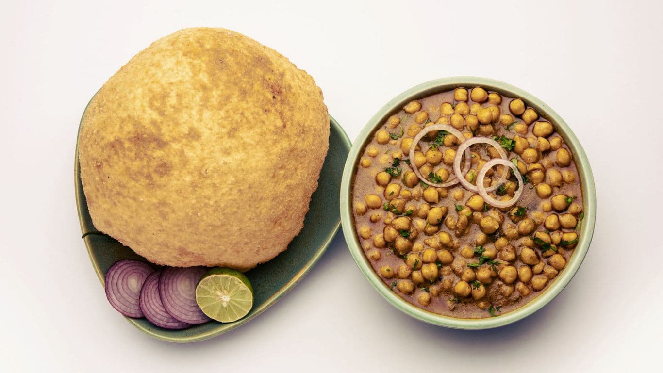 Indian chole bhature with onions and lime