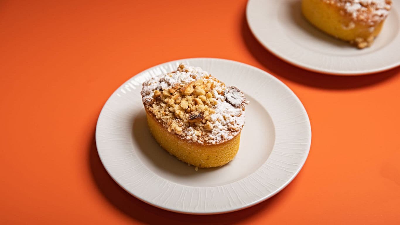 Crumb Topped Cake Slice on White Plate