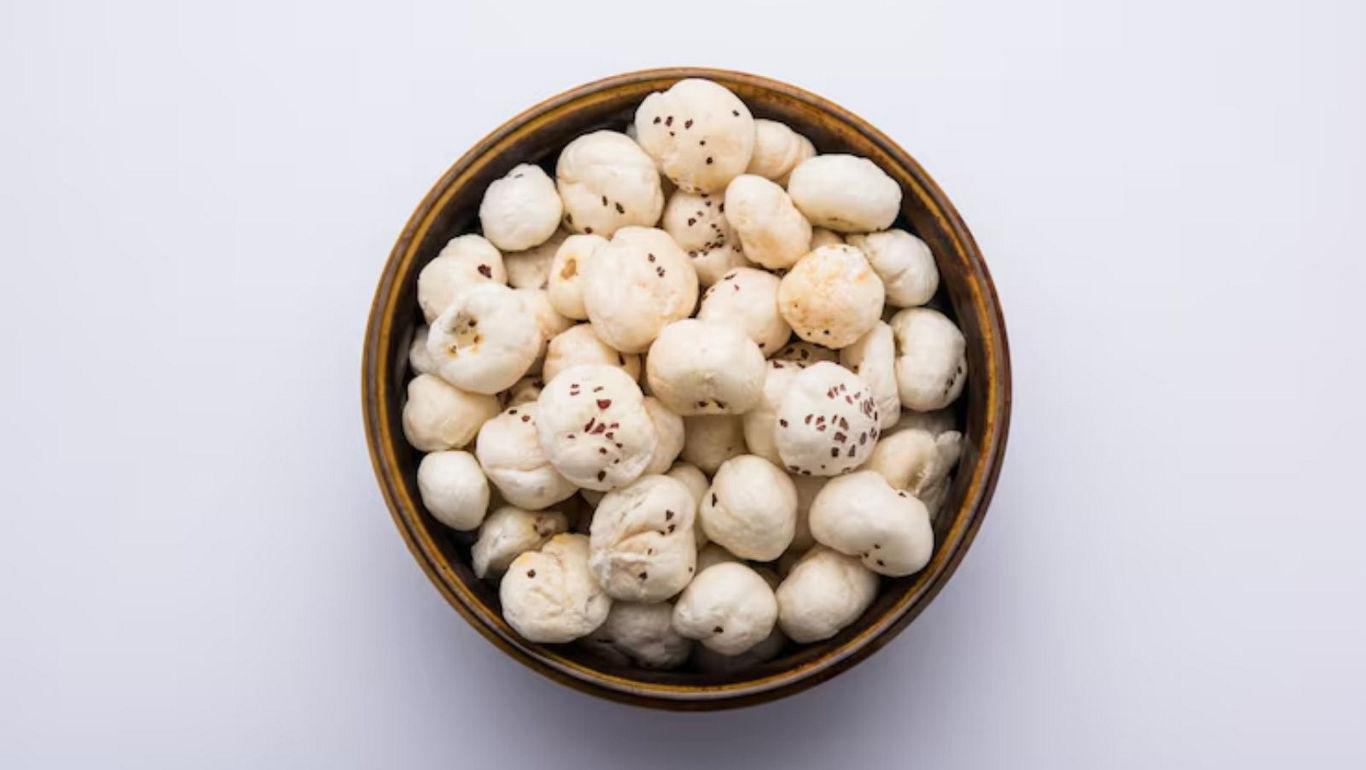 Bowl of puffed lotus seeds on white
