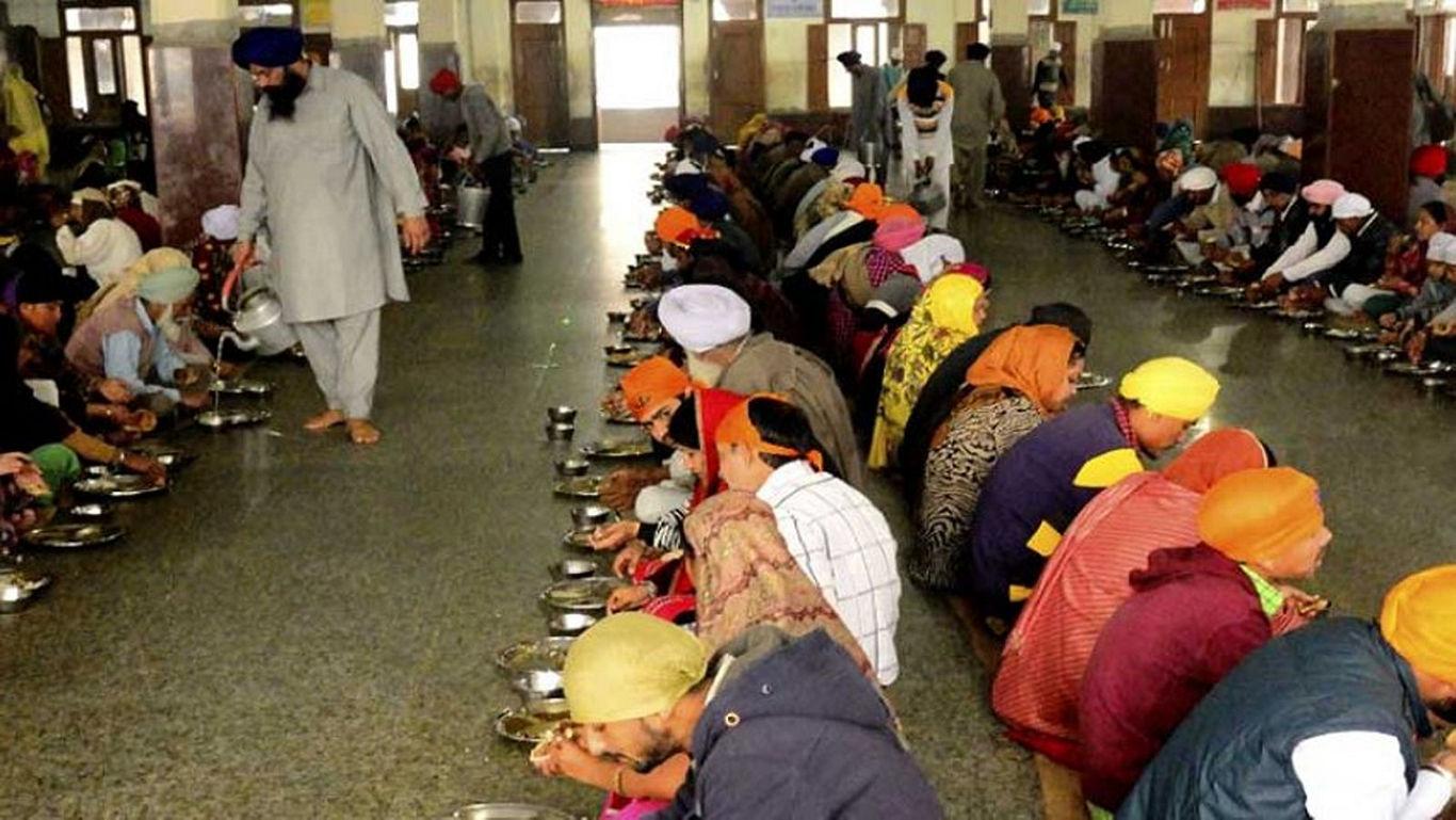 A Sewadaar serving food at Langar