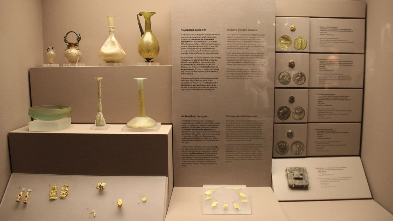 Ancient glass vessels and gold artifacts display