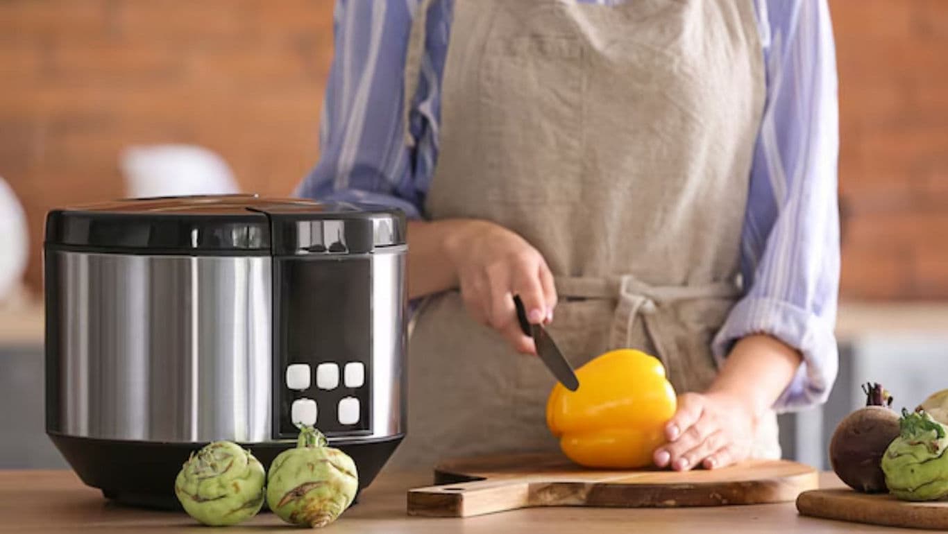 Modern kitchen with multi-cooker and vegetables