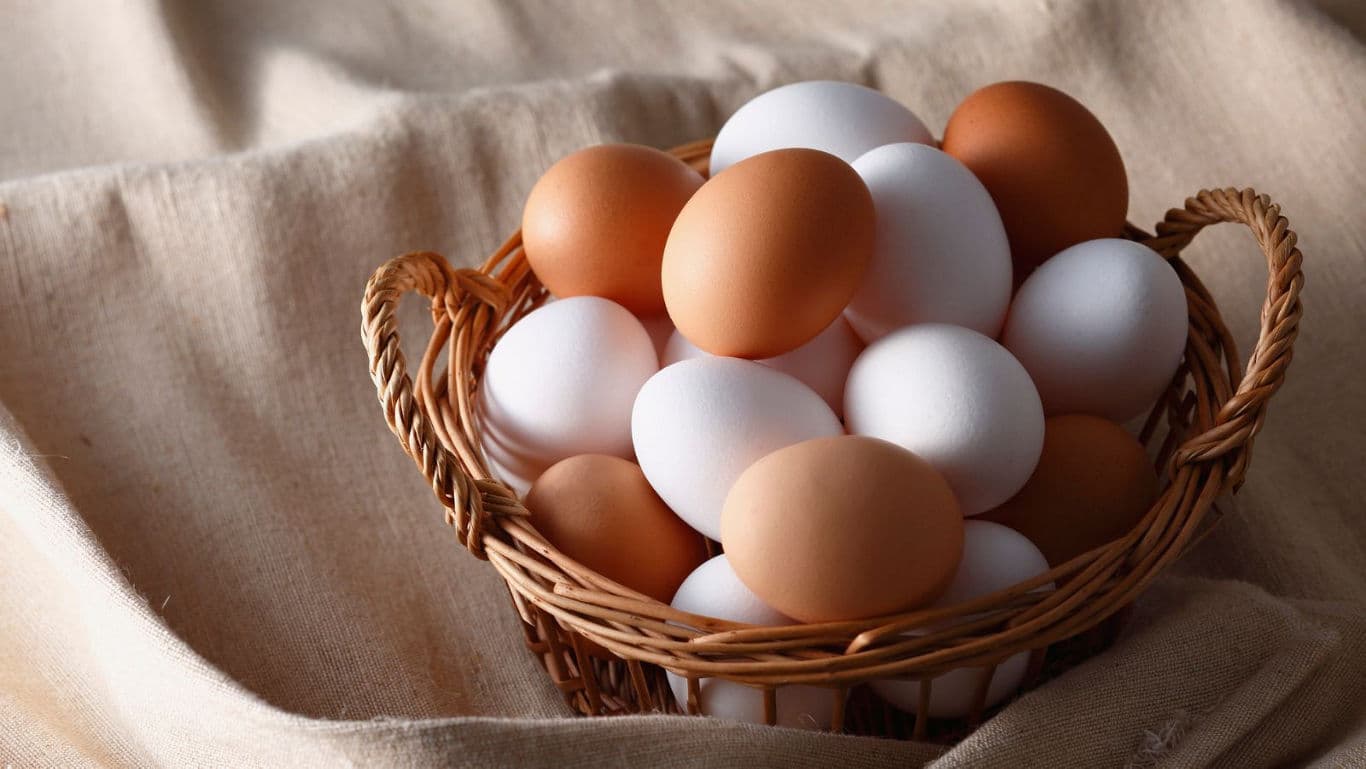 Basket of Brown and White Eggs on Cloth
