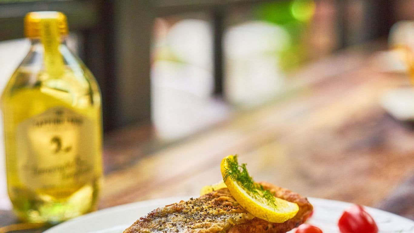 Grilled fish fillet with lemon garnish