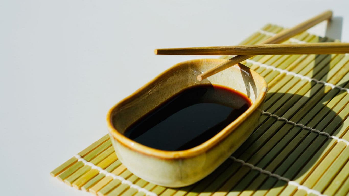 Soy sauce in ceramic dish with chopsticks