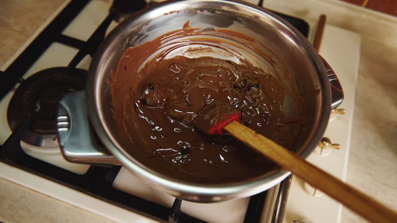 Melting chocolate in saucepan on stovetop
