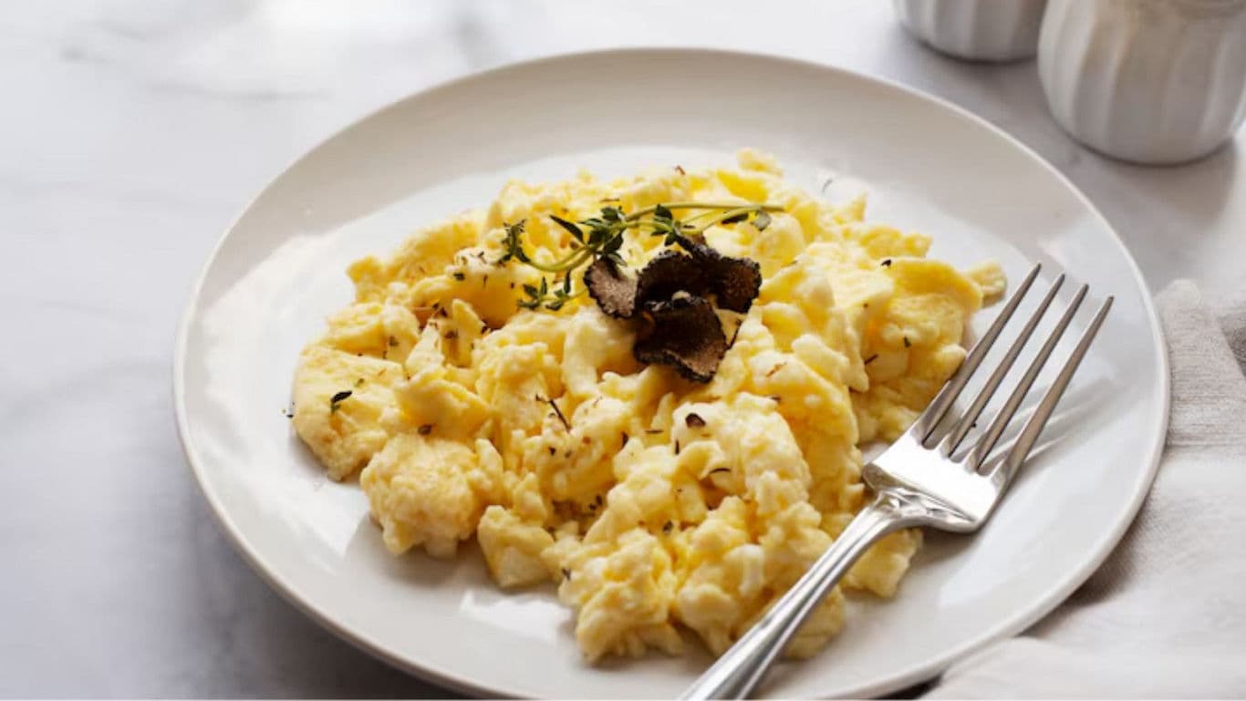 Scrambled Eggs with Black Truffle Garnish on Plate
