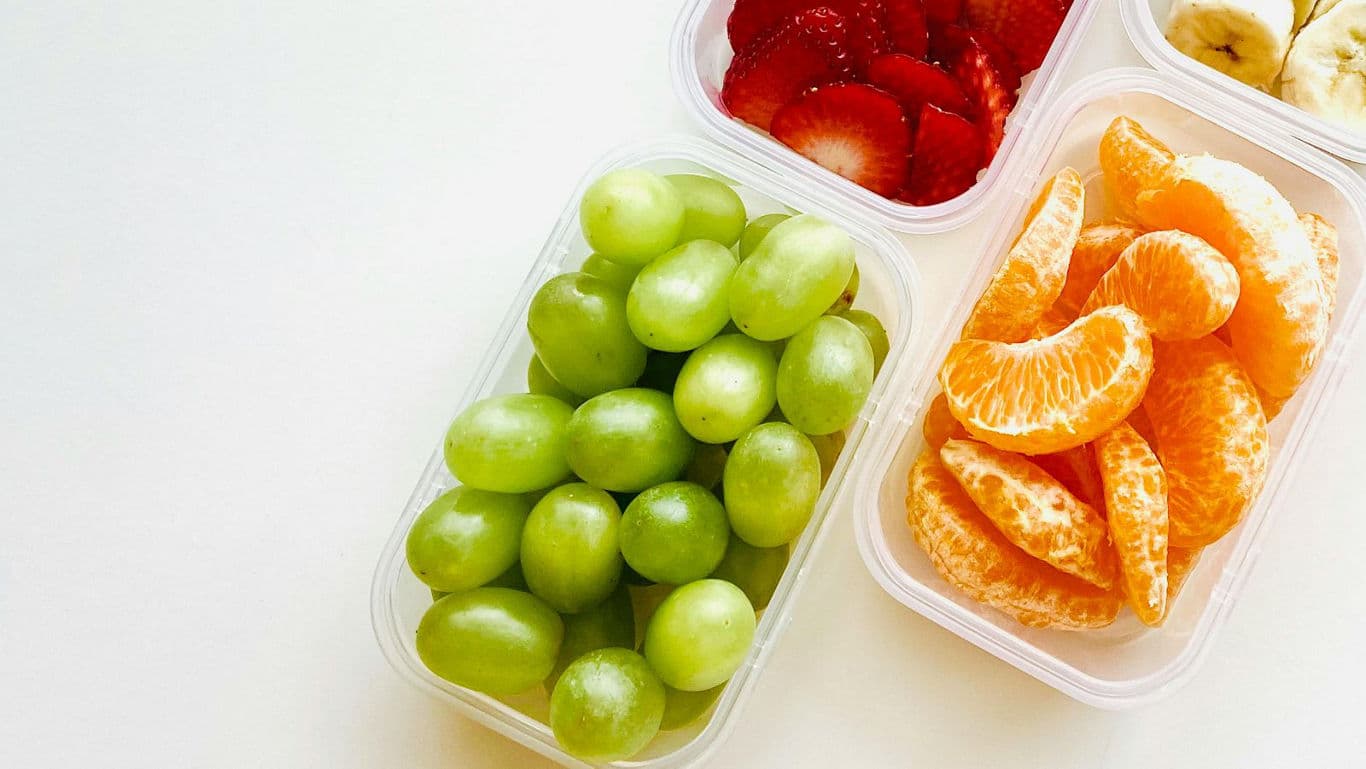 Assorted fresh fruit in plastic containers
