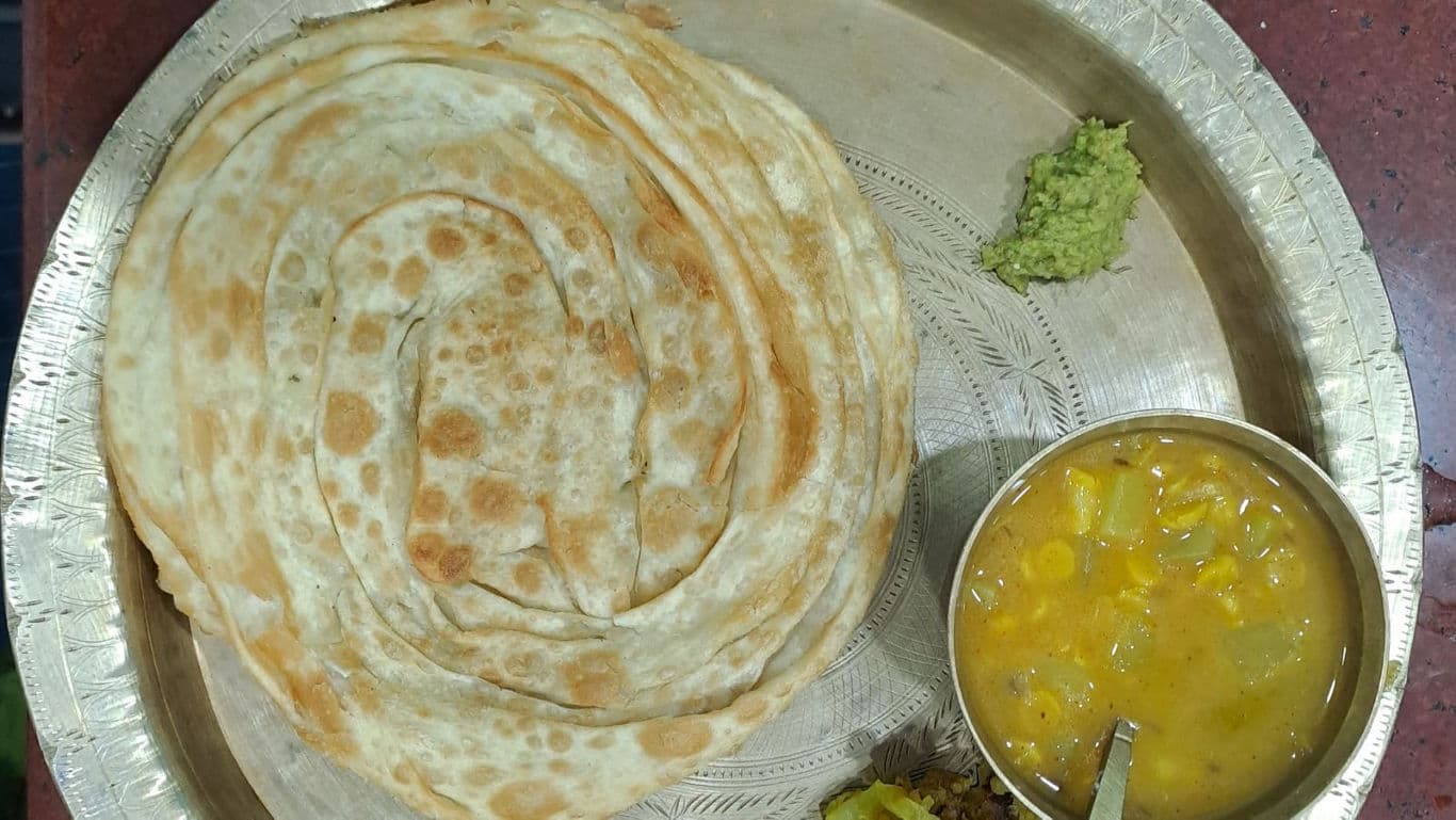 South Indian parotta with curry on plate