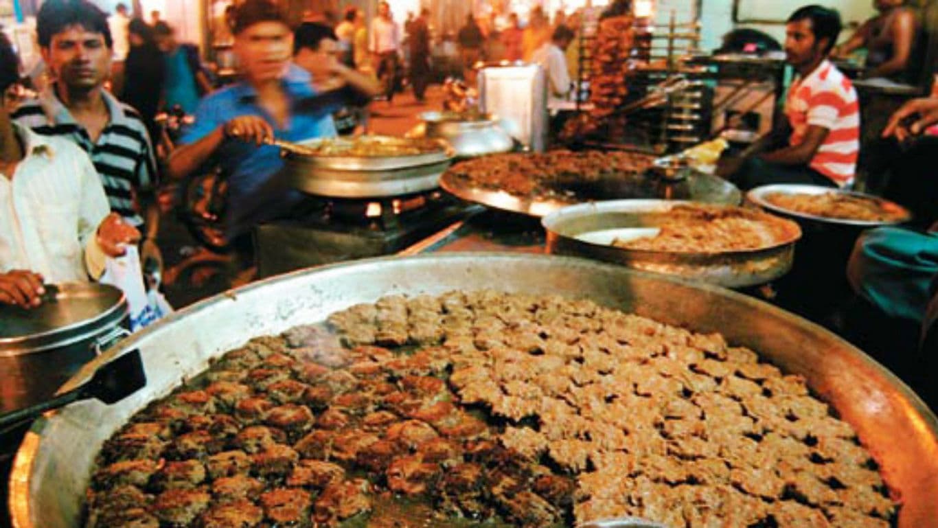 Large skillet of kebabs at bustling street market