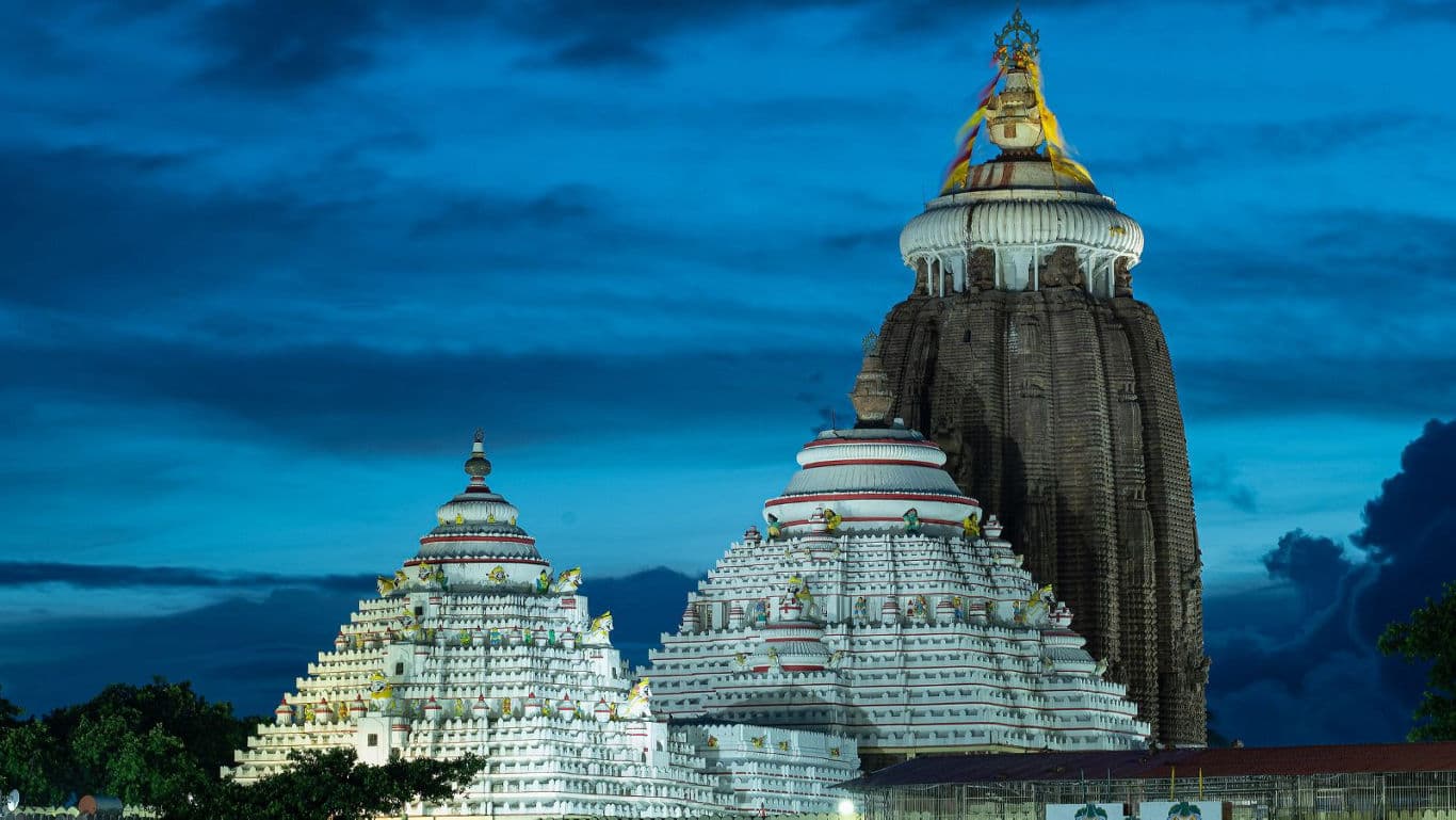 Illuminated ancient temple complex at dusk