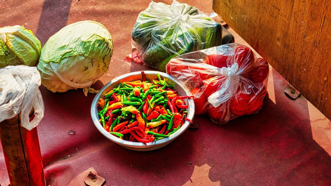 Fresh vegetables and chili peppers on display