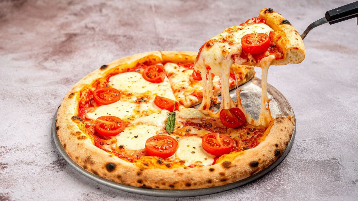 Cheesy Margherita Pizza Slice Being Served