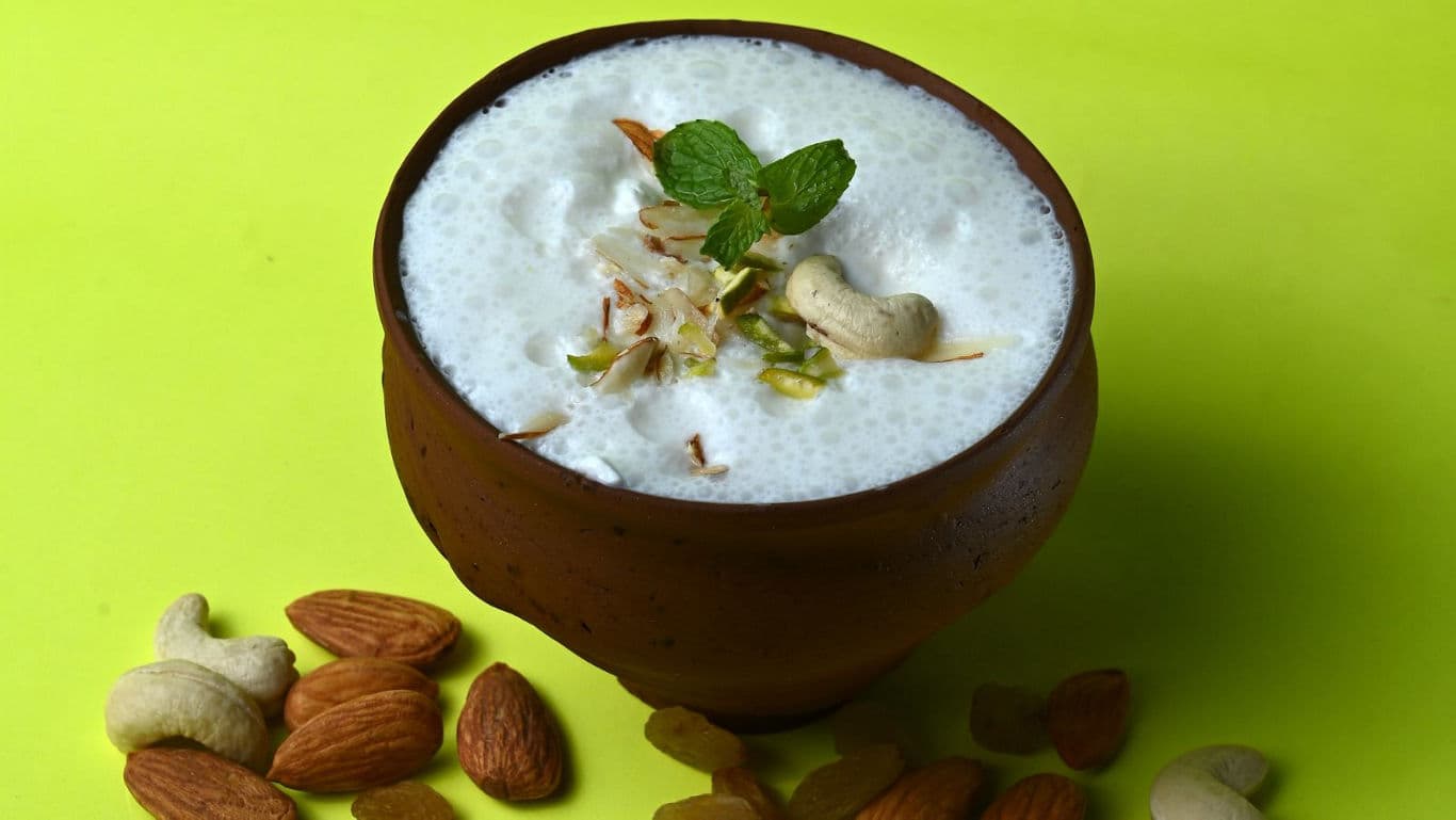 Traditional yogurt drink in clay cup with nuts