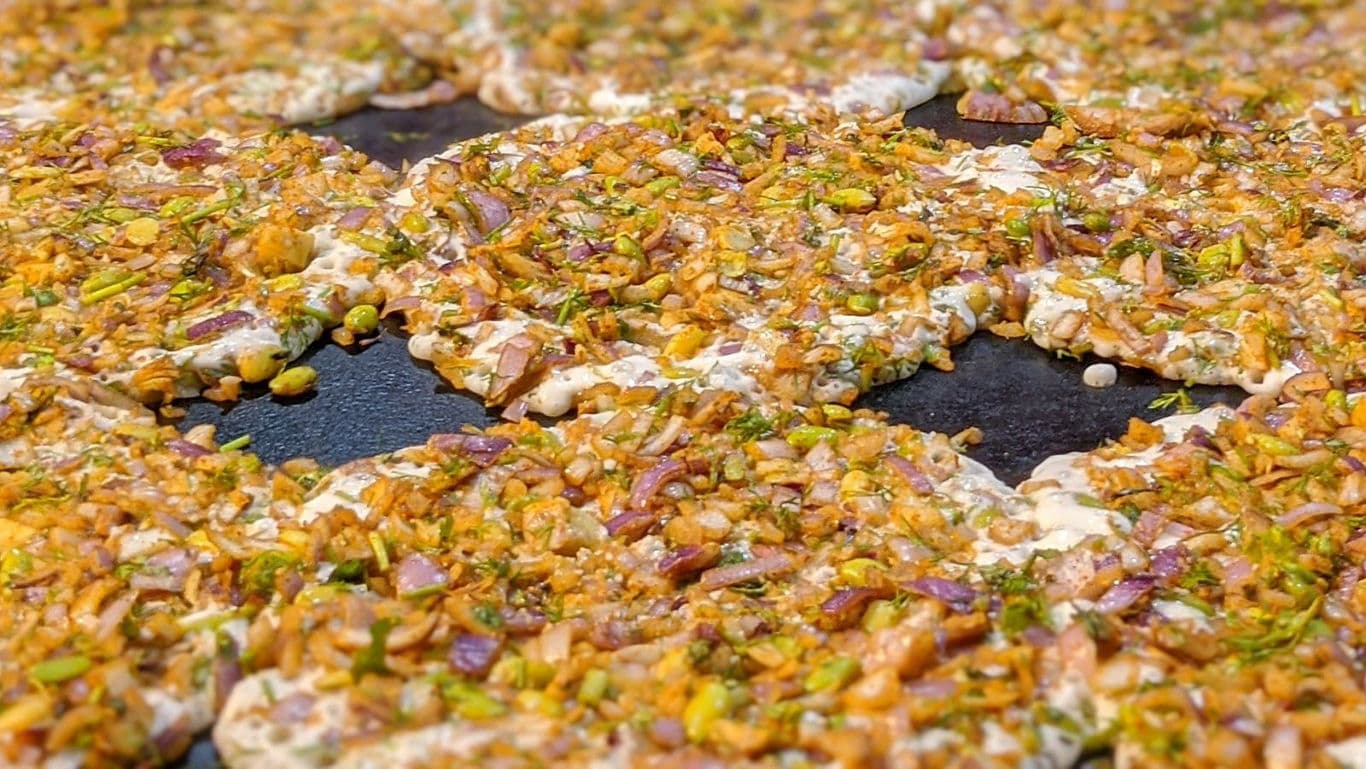 Close-up of Indian savory pancakes cooking on griddle