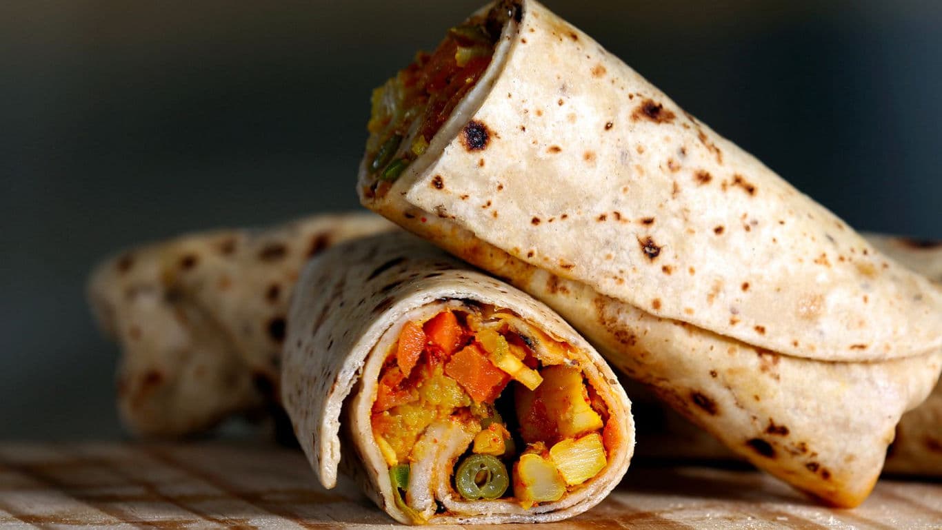 Close-up of vegetable stuffed tortilla wraps on table