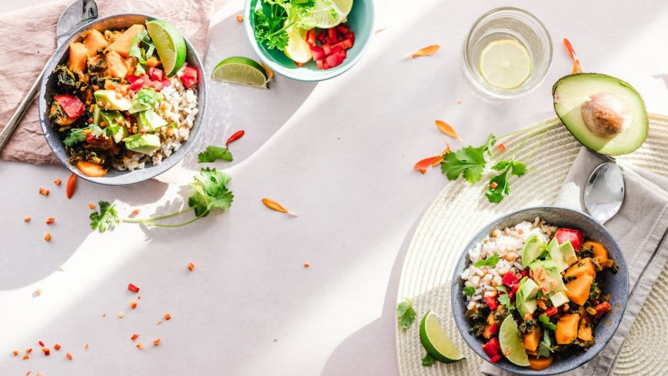 Fresh vegetable rice bowls with avocado and lime