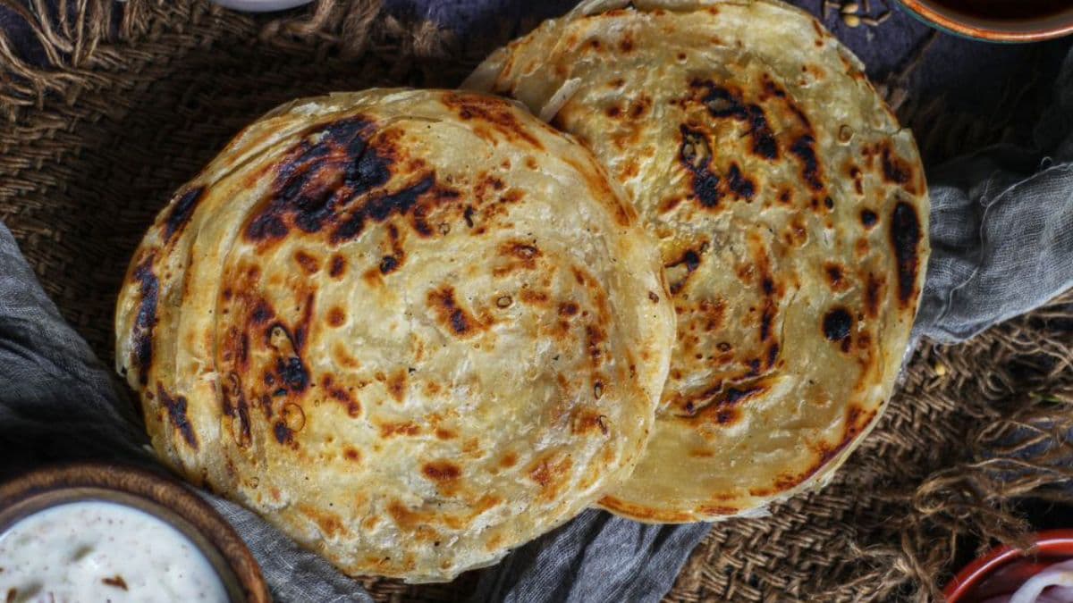 2 khapli atta laccha parathas on a plate