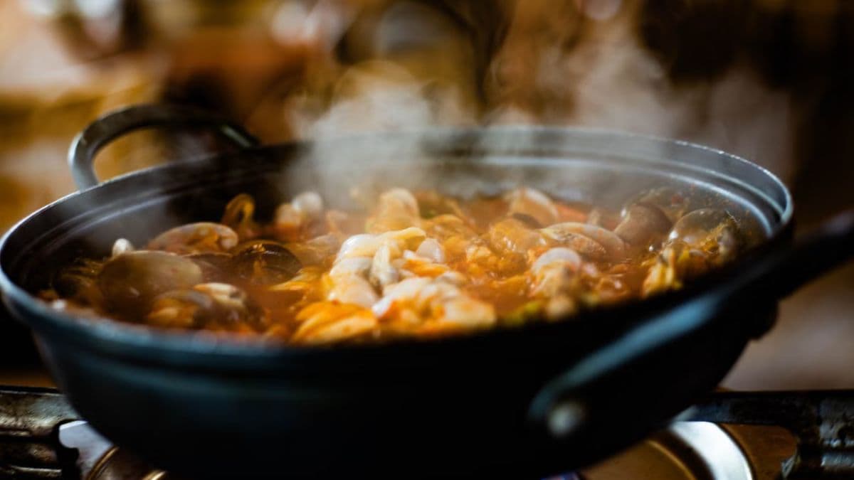 Clams being cooked in a wok
