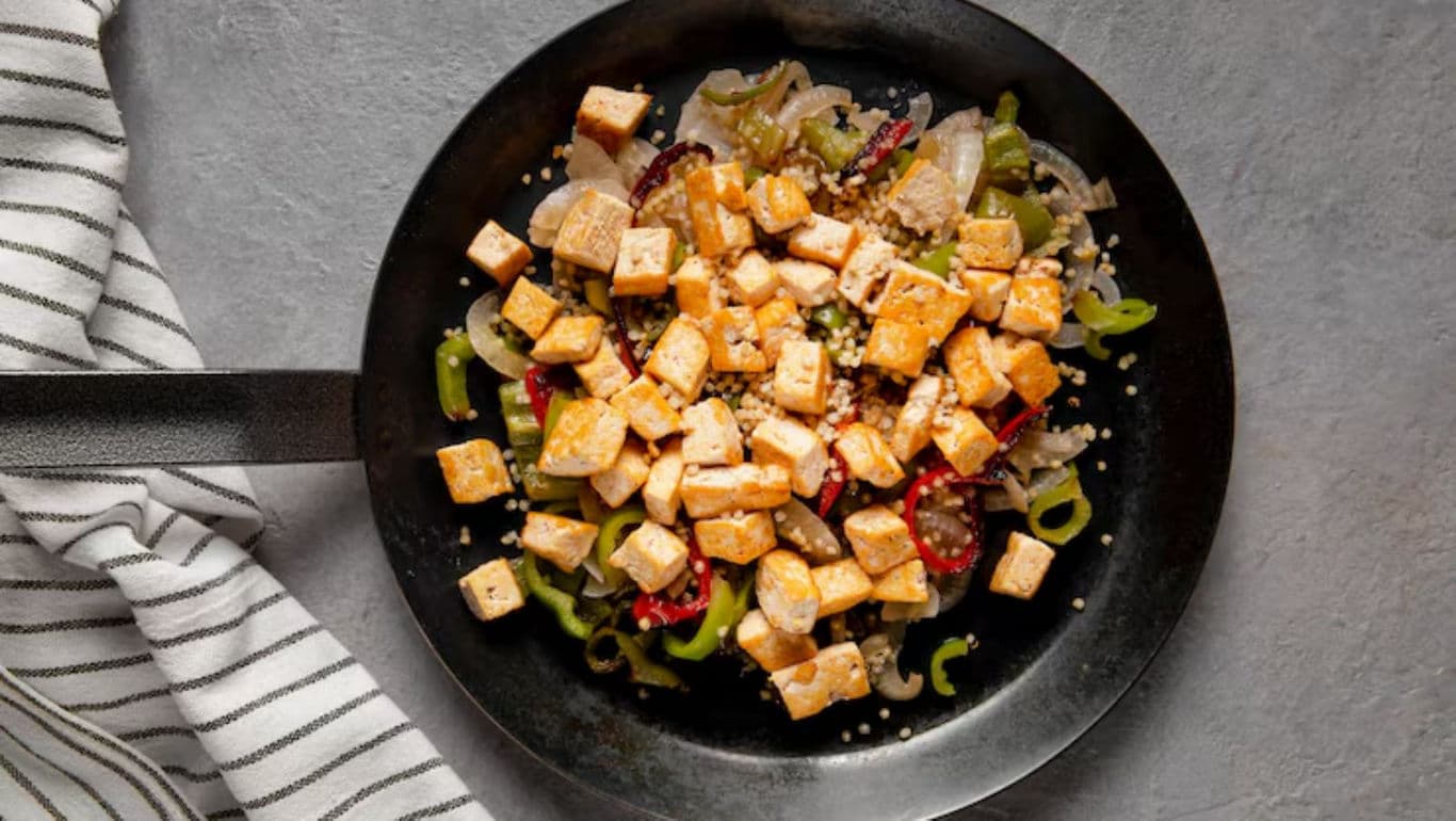 Sautéed tofu with vegetables in skillet