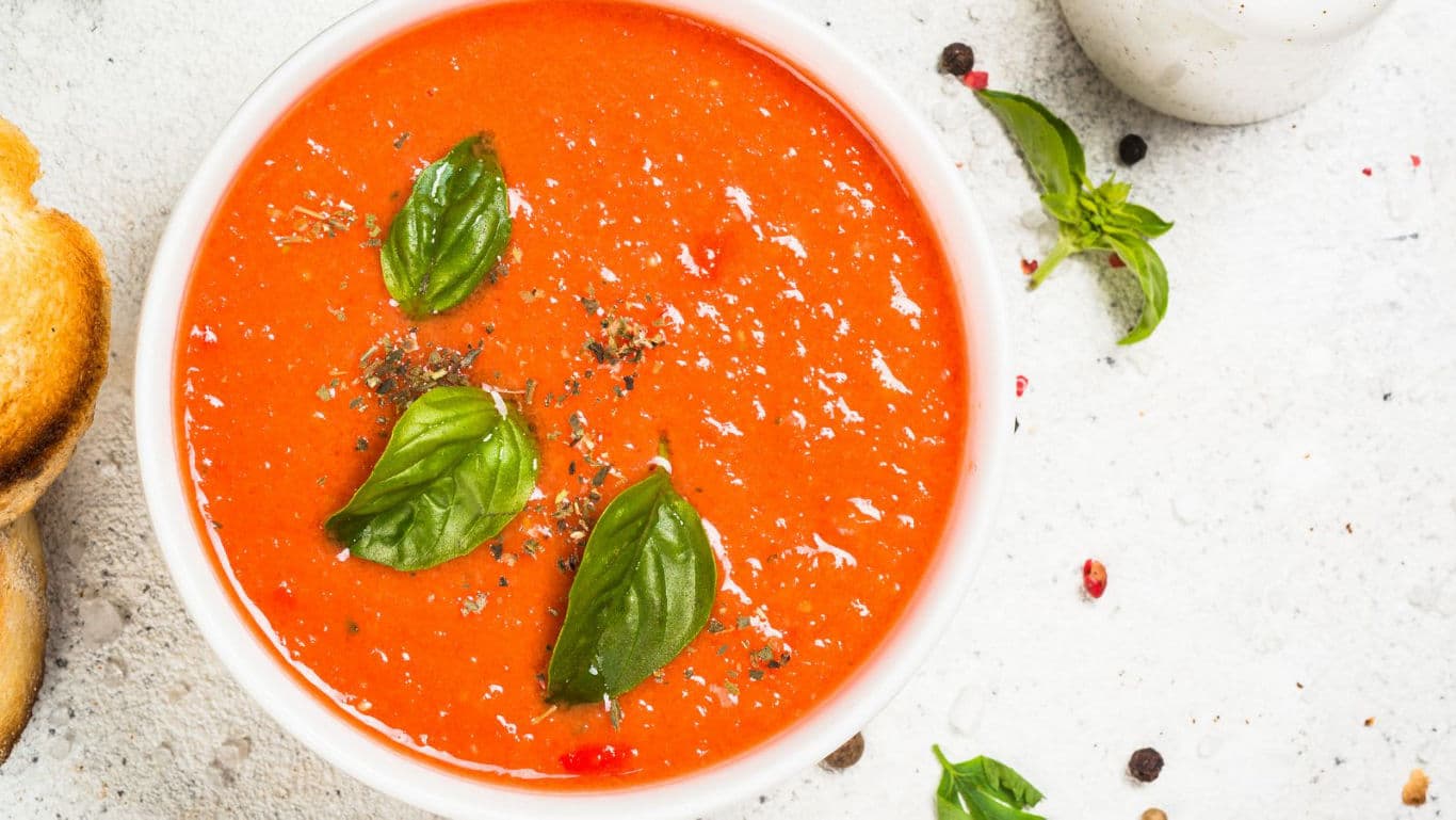 Bowl of tomato soup with fresh basil