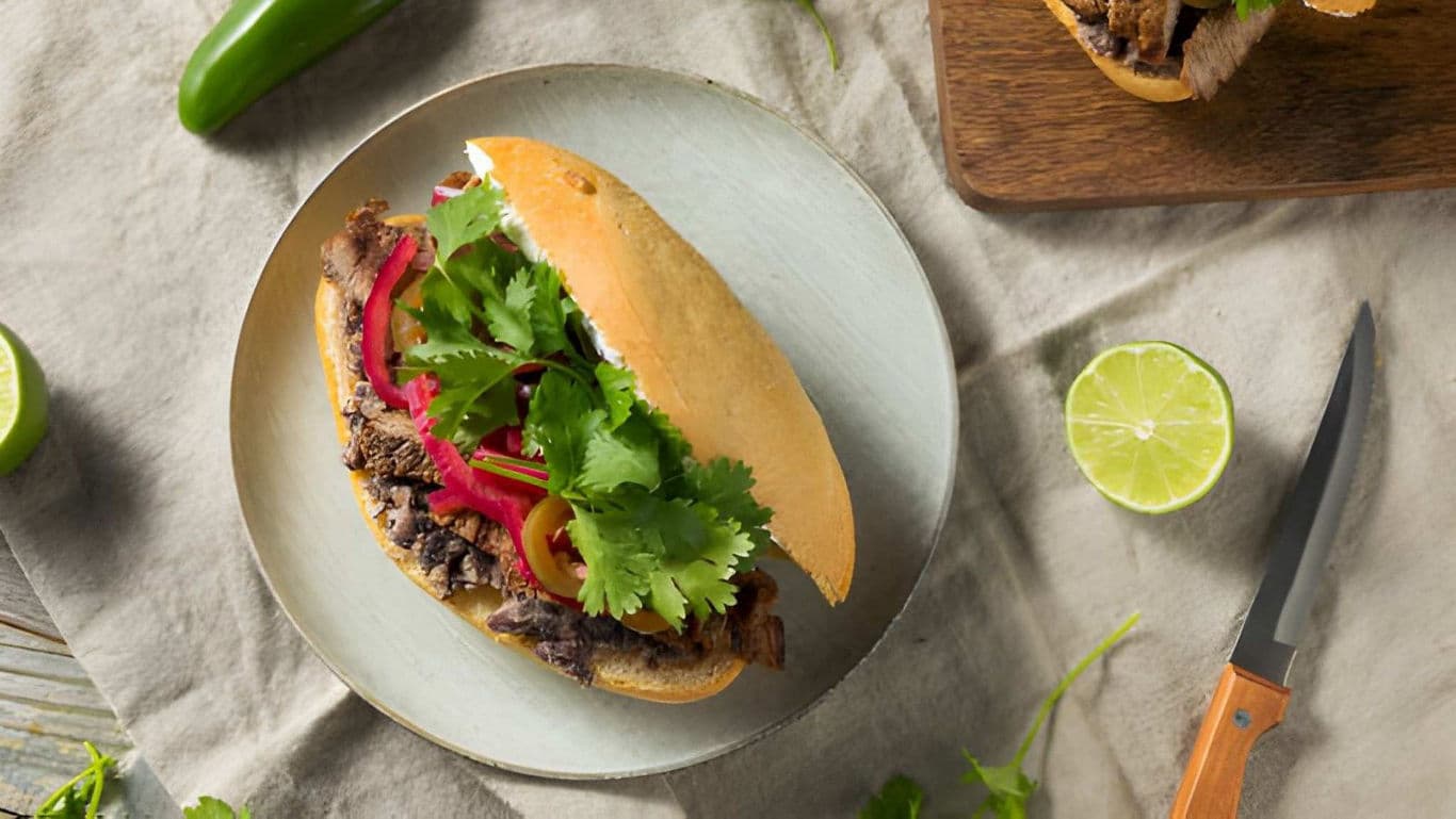Mexican torta sandwich with beef and fresh cilantro