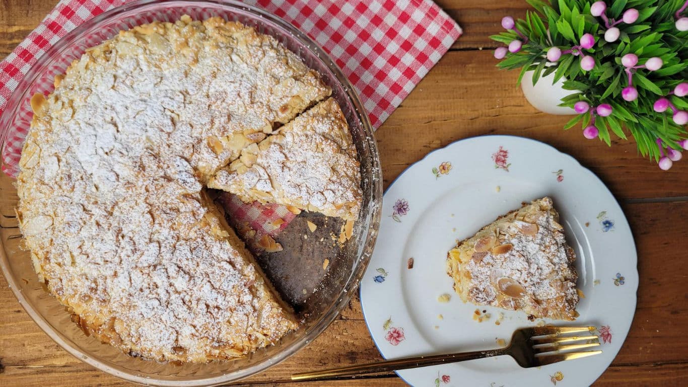 Almond crumb cake slice on floral plate