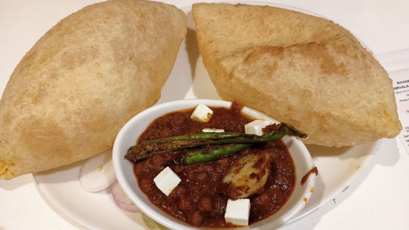Indian chole bhature with paneer garnish