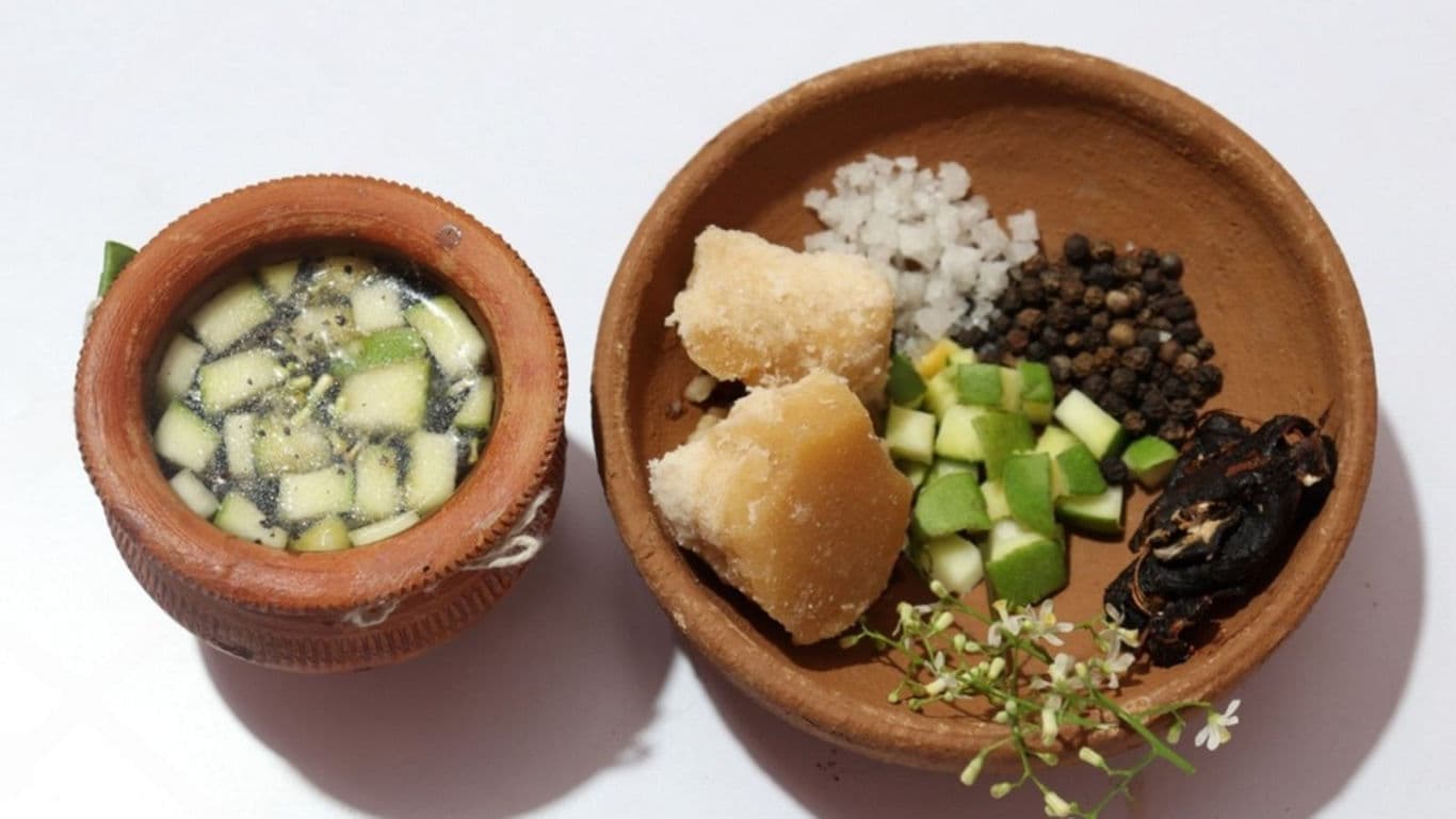 Traditional Herbal Drink with Fresh Ingredients in Clay Bowls