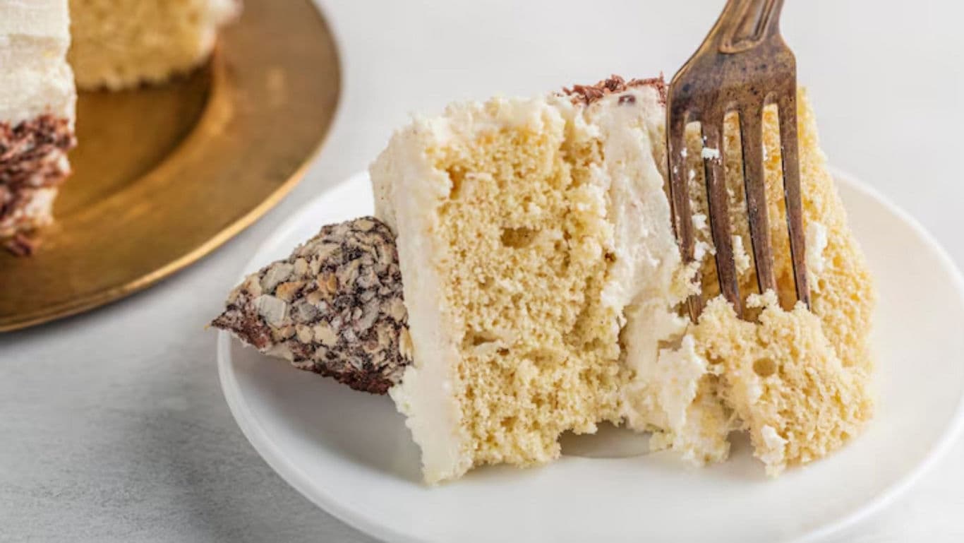 Slice of vanilla layer cake on plate